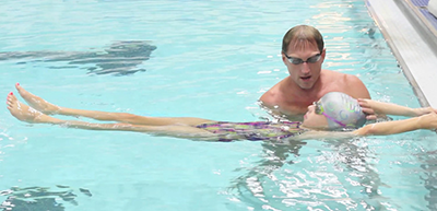 Pete Sczupak teaching a child to swim